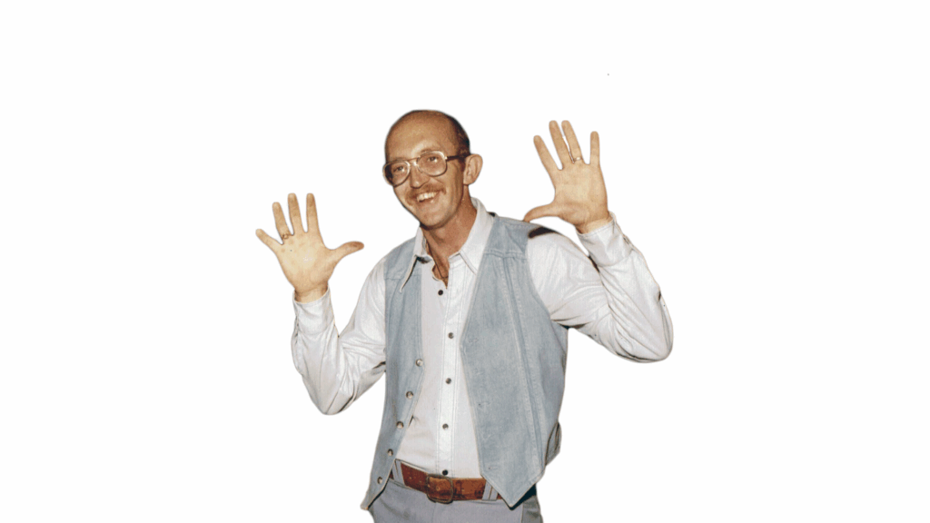 Don Storrs smiling with hands in the air